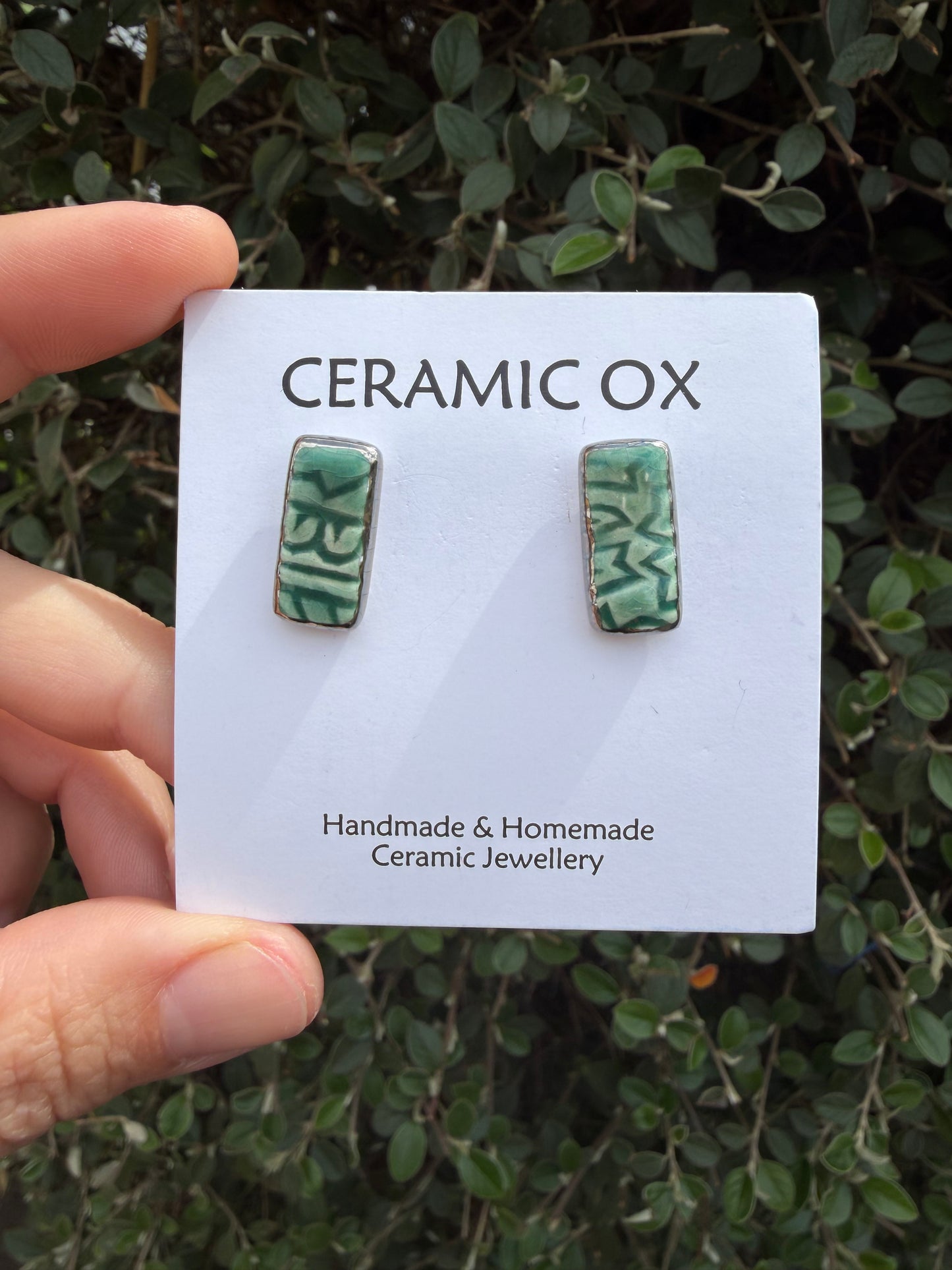 Emerald green block print rectangle studs with silver surround
