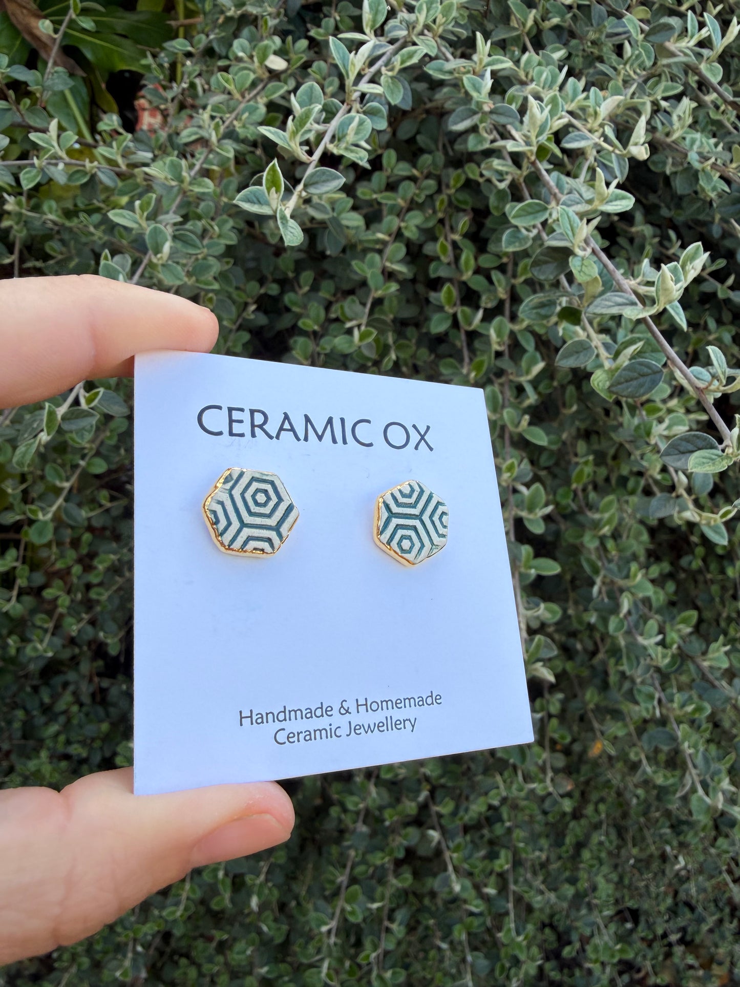 Hexagon studs with dark green geometric pattern