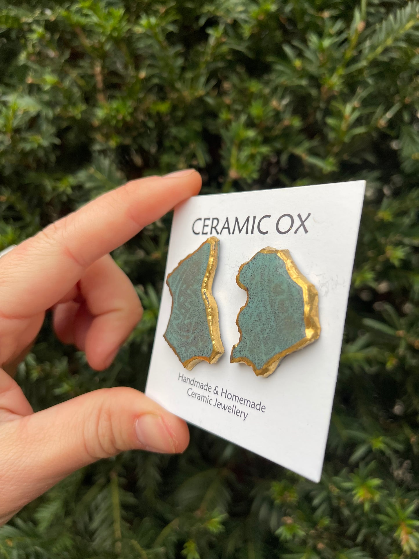 Black clay asymmetric statement studs