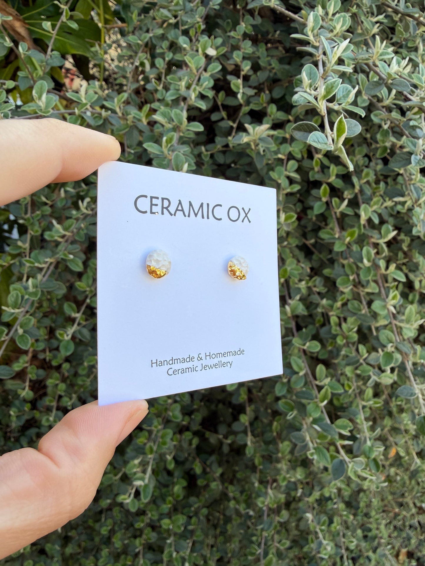 White textured studs with gold accent