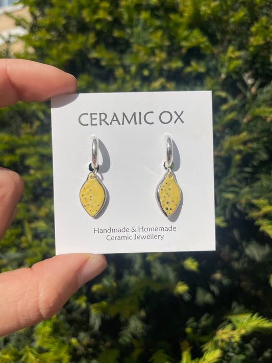 Small lemon charms on Huggie hoops with Platinum surround