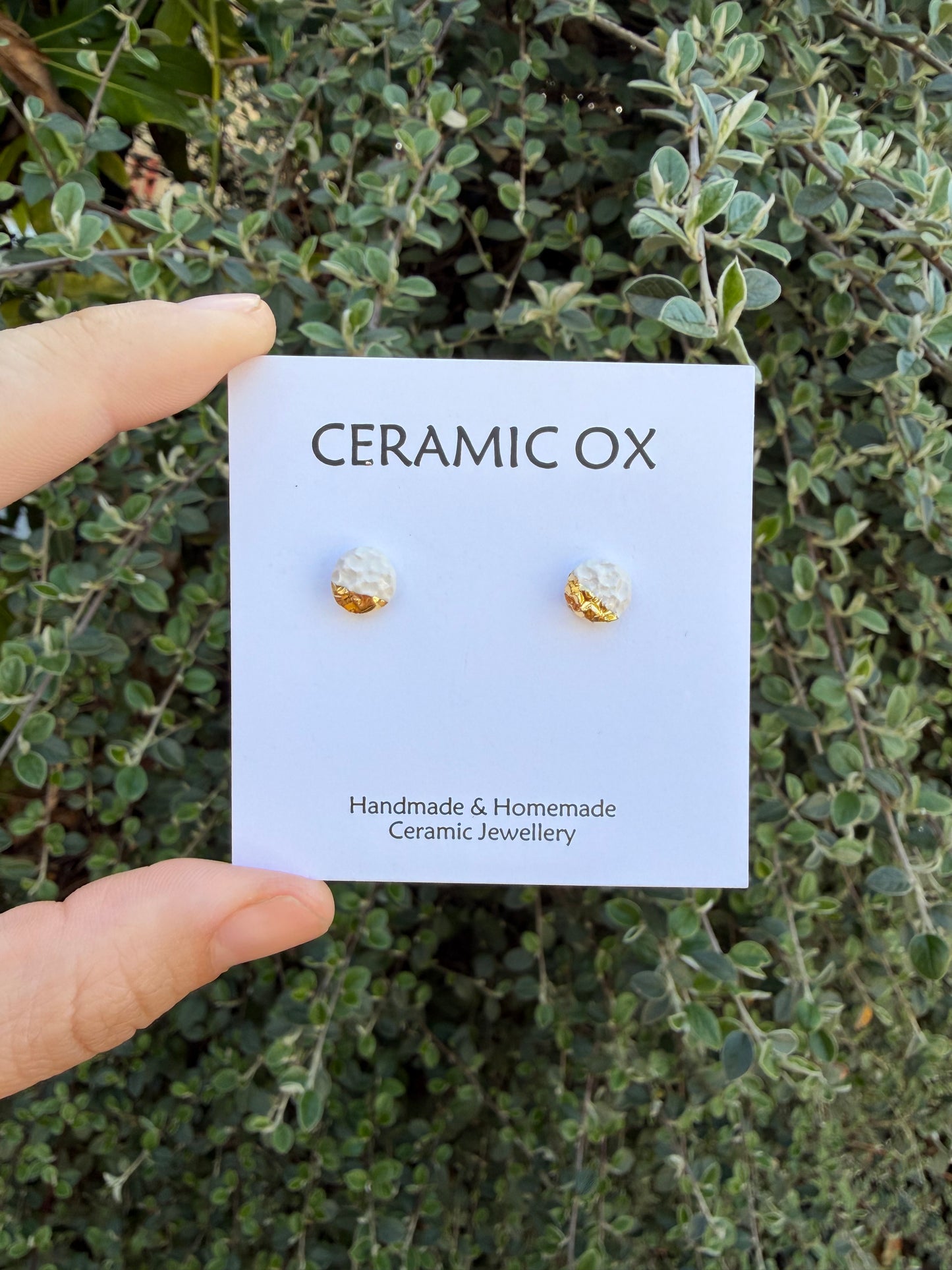 White textured studs with gold accent