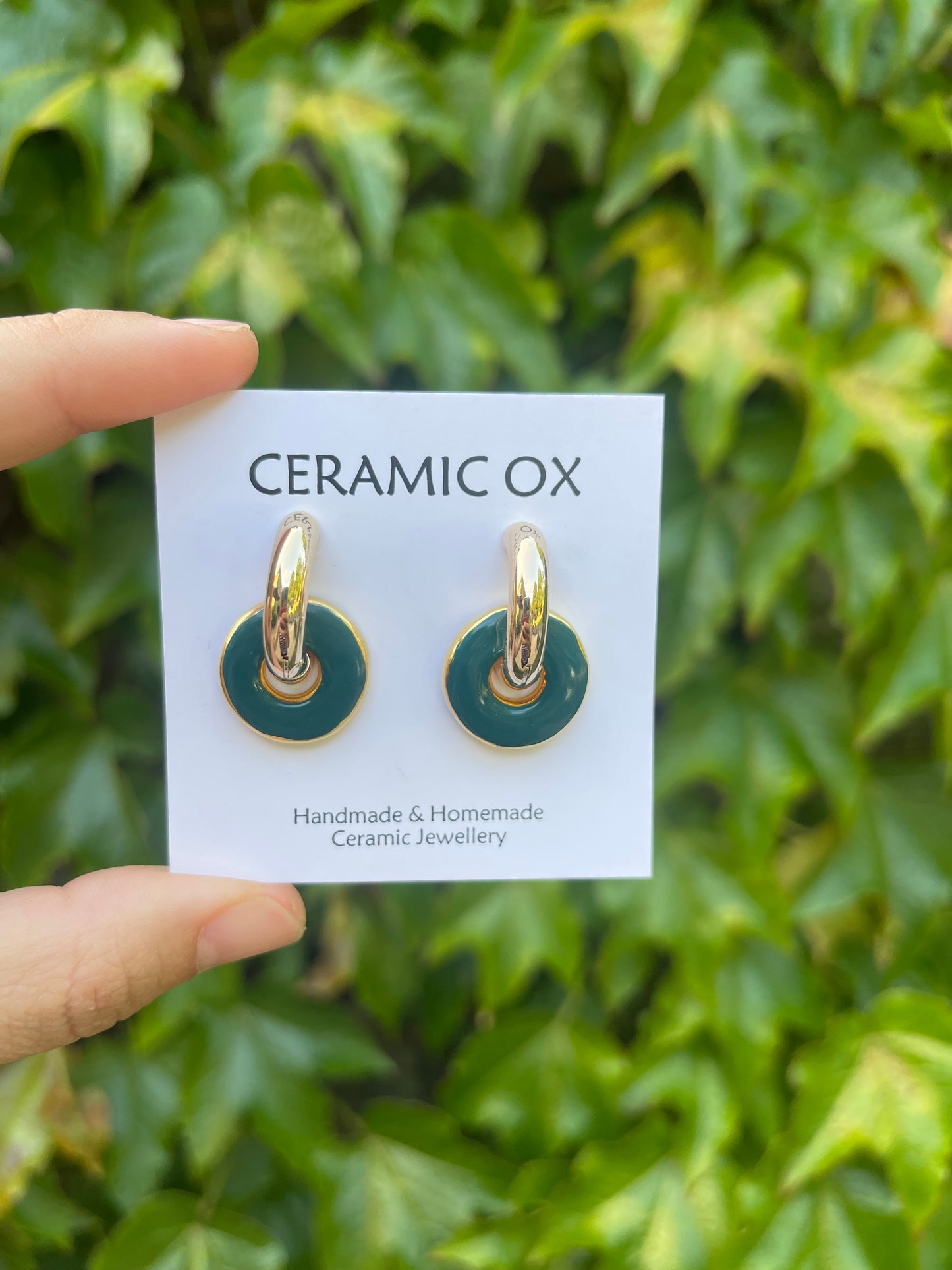Teal circles on chunky golden hoops