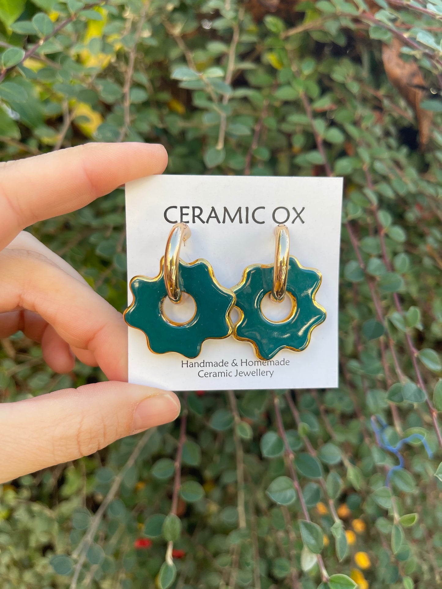 Puddle on chunky gold hoops in Teal