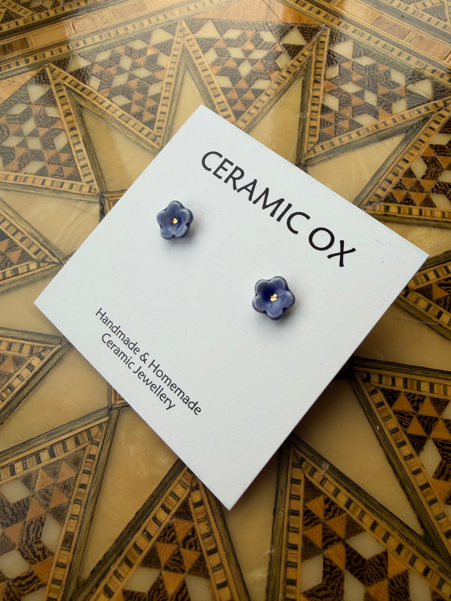 Tiny blue flower studs