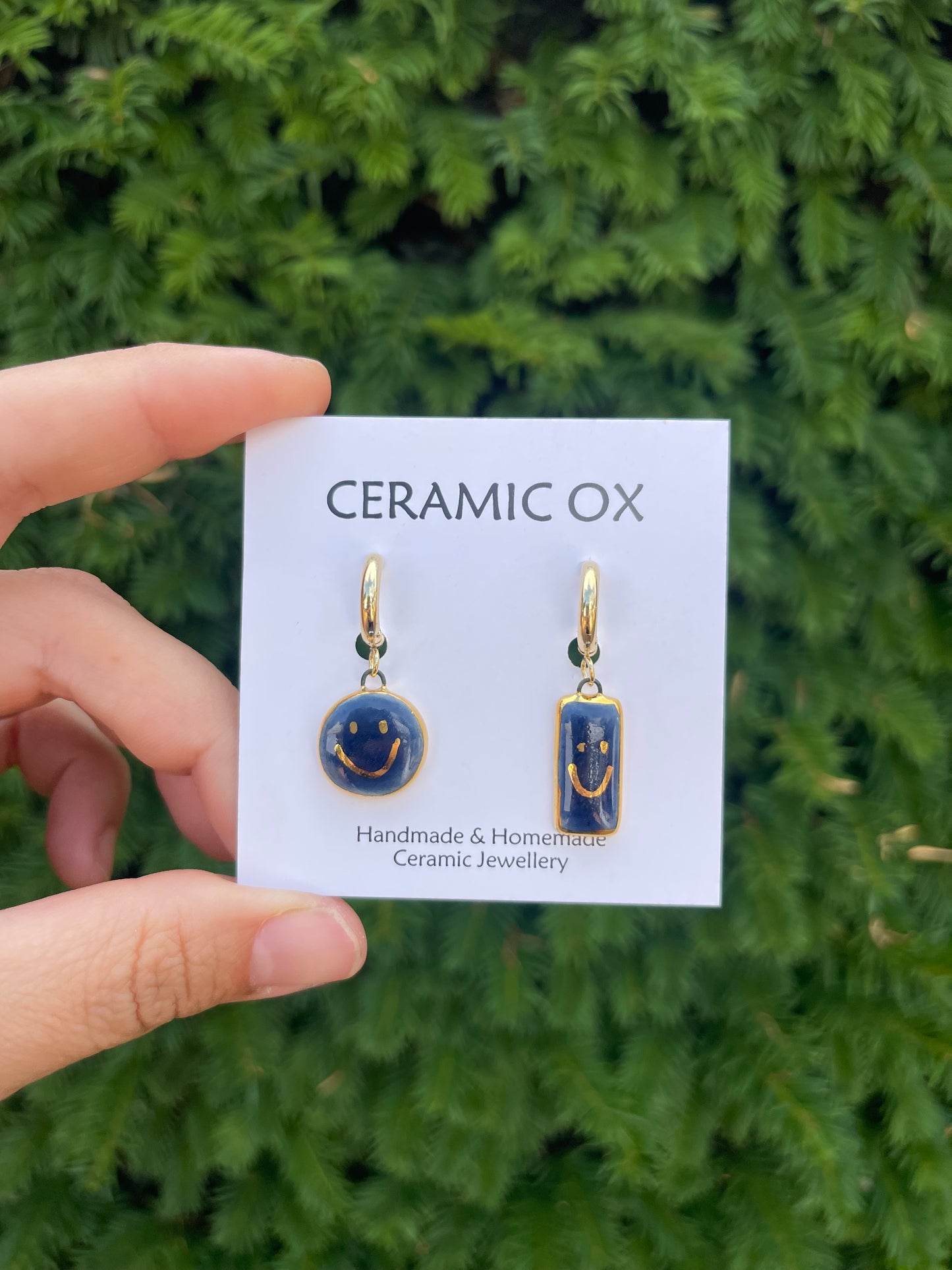Navy asymmetric smiley face hoops