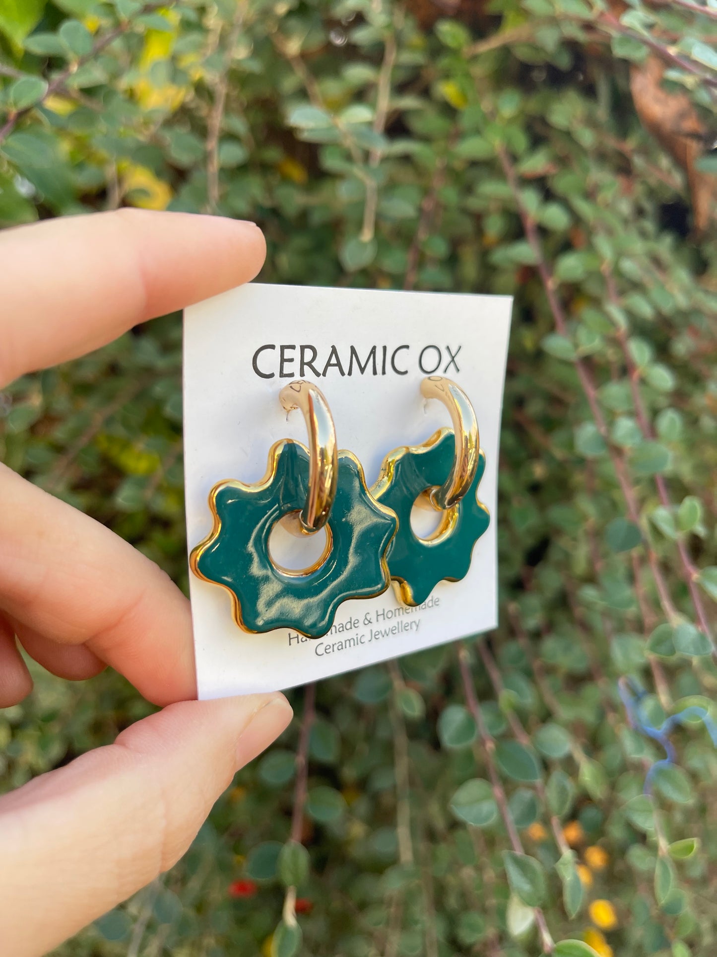 Puddle on chunky gold hoops in Teal