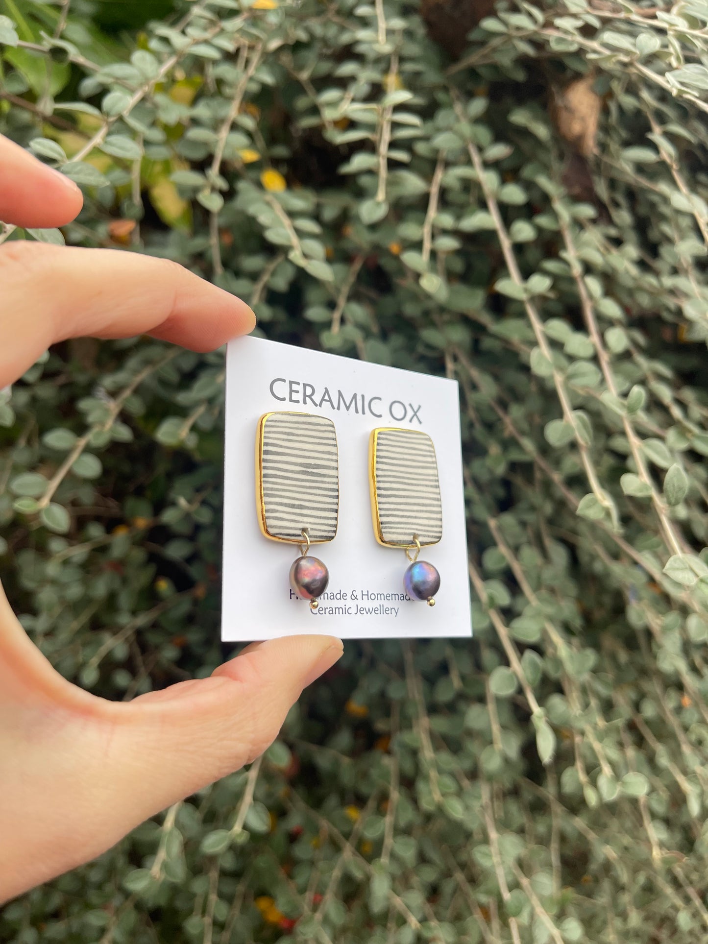 Black striped rectangle studs with black peacock freshwater pearls.