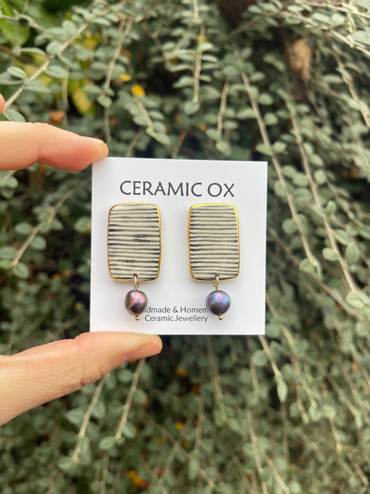 Black striped rectangle studs with black peacock freshwater pearls.