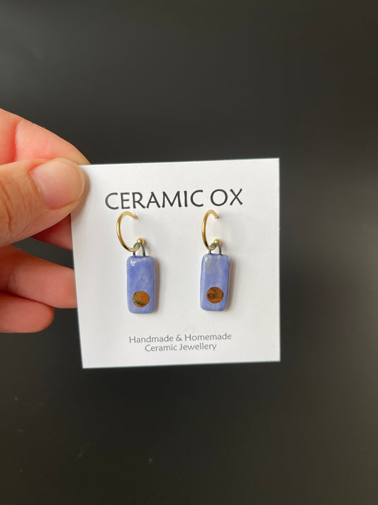 Gold circle on blue with gold plated hoops