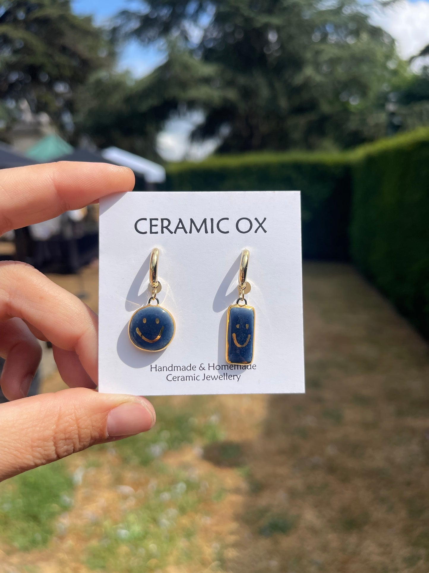 Navy asymmetric smiley face hoops