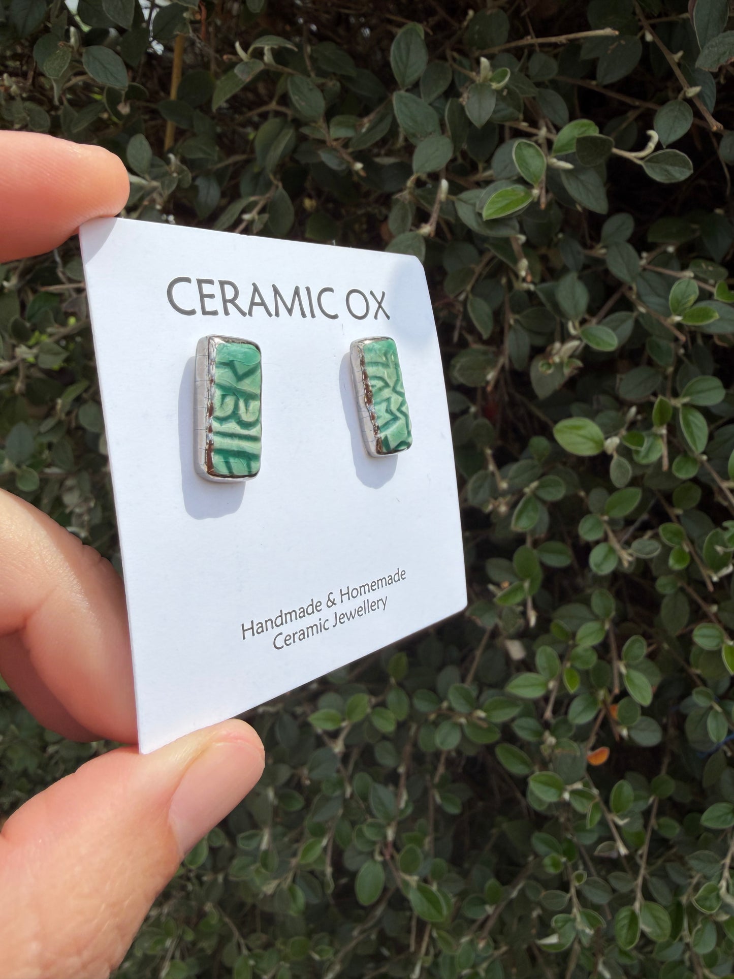 Emerald green block print rectangle studs with silver surround