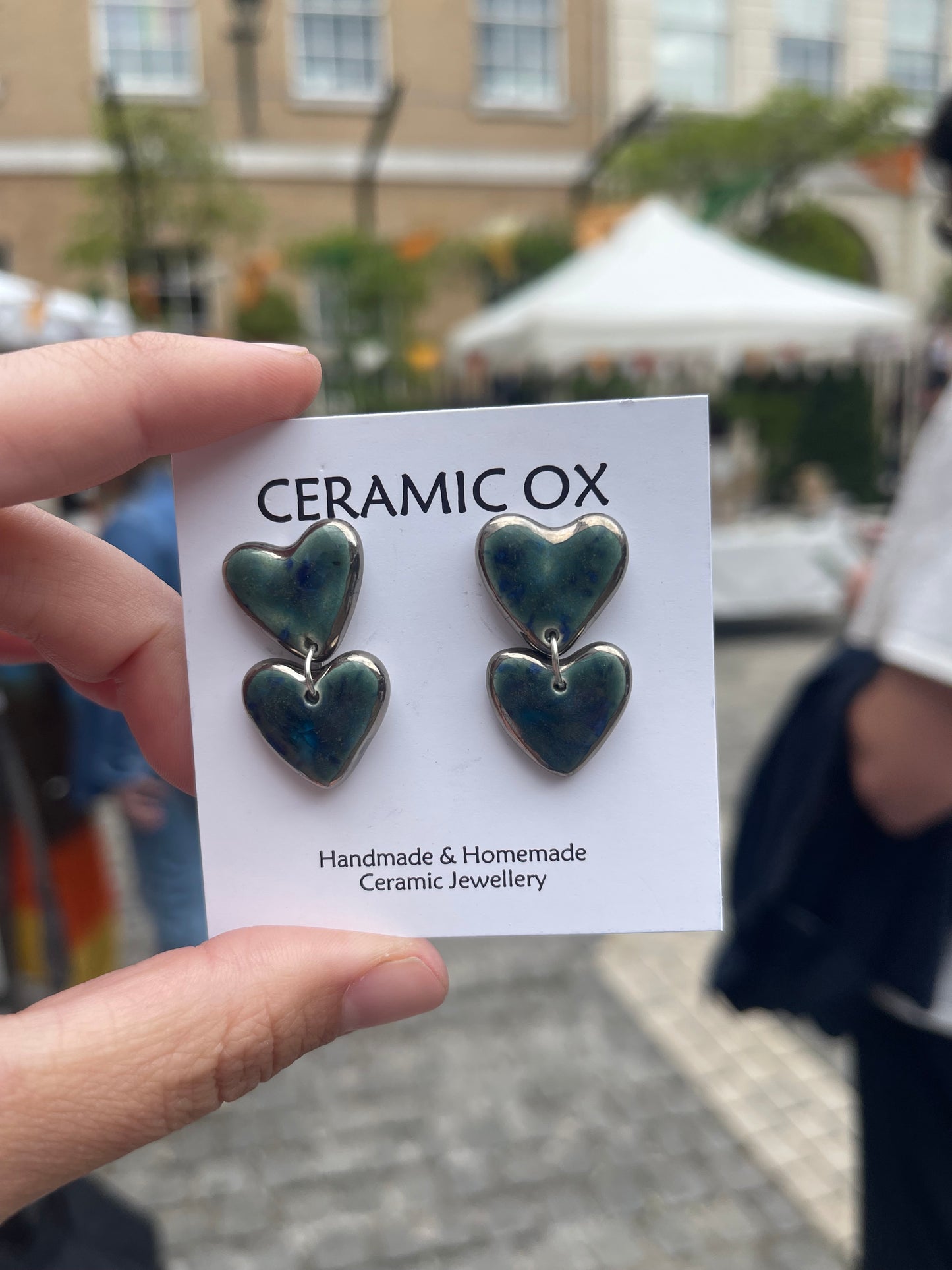 Platinum surround double hearts dangly stud in ‘storm’