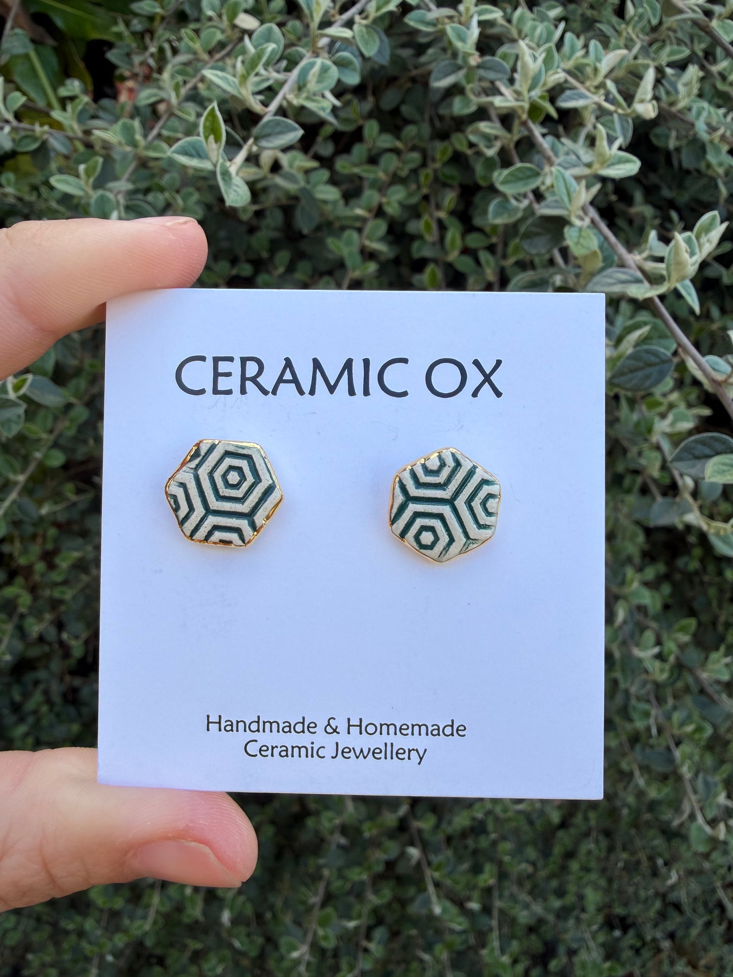 Hexagon studs with dark green geometric pattern
