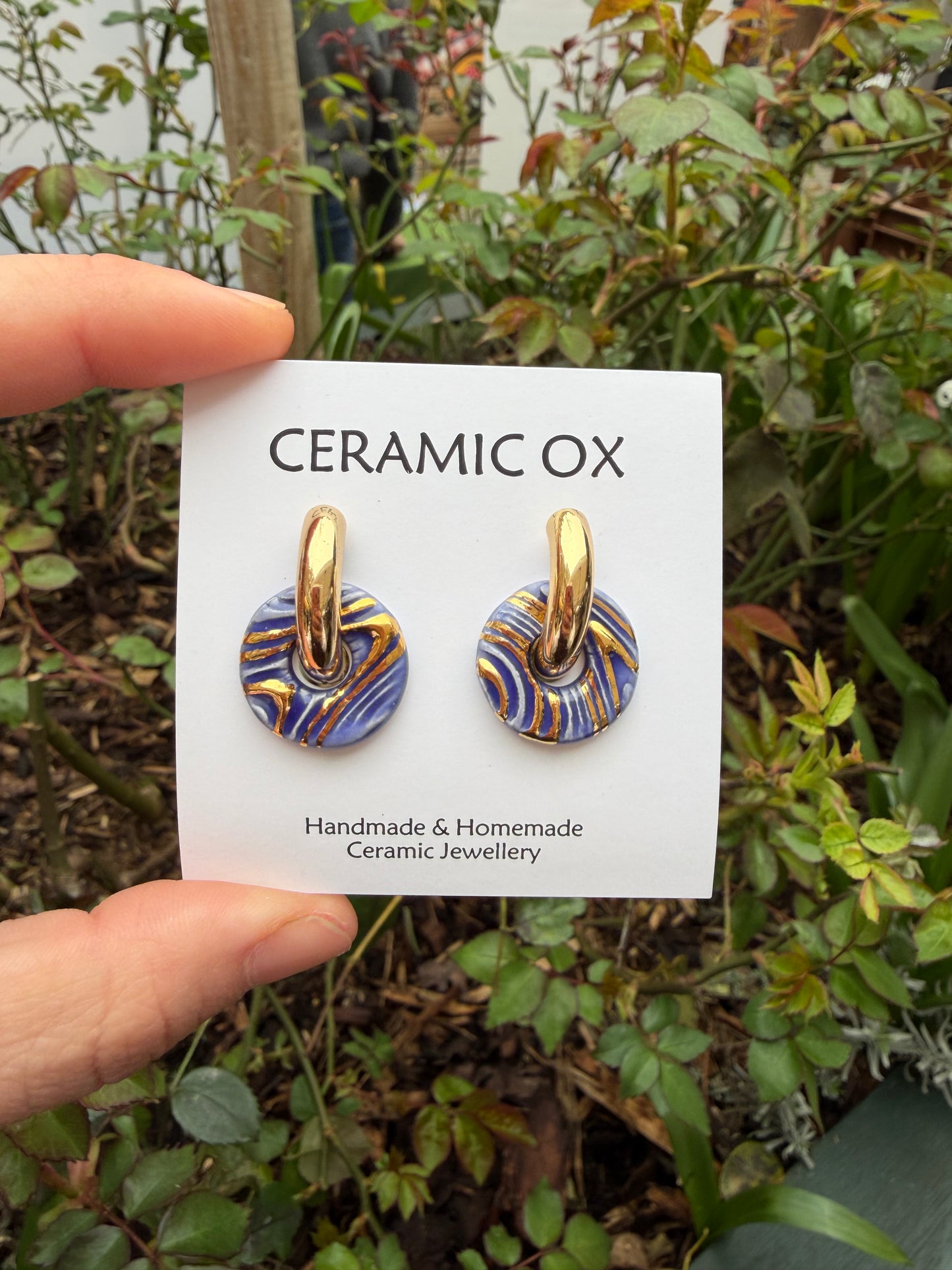 Fingerprint hoops in sapphire blue on chunky gold hoops