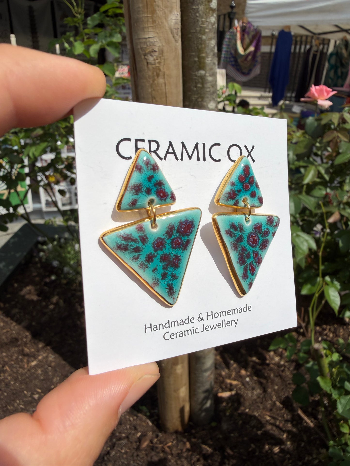 Speckled double triangle dangly studs