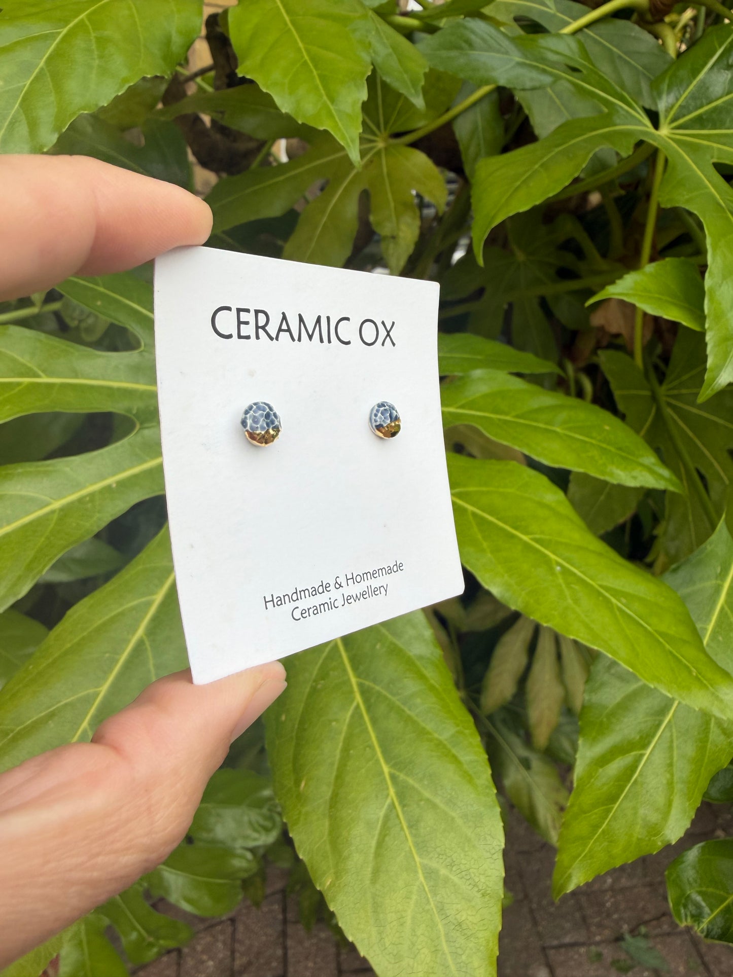Tiny navy texture studs with gold accent