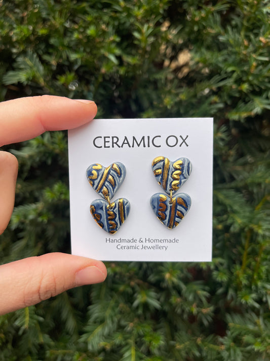 Double navy block print heart dangle studs