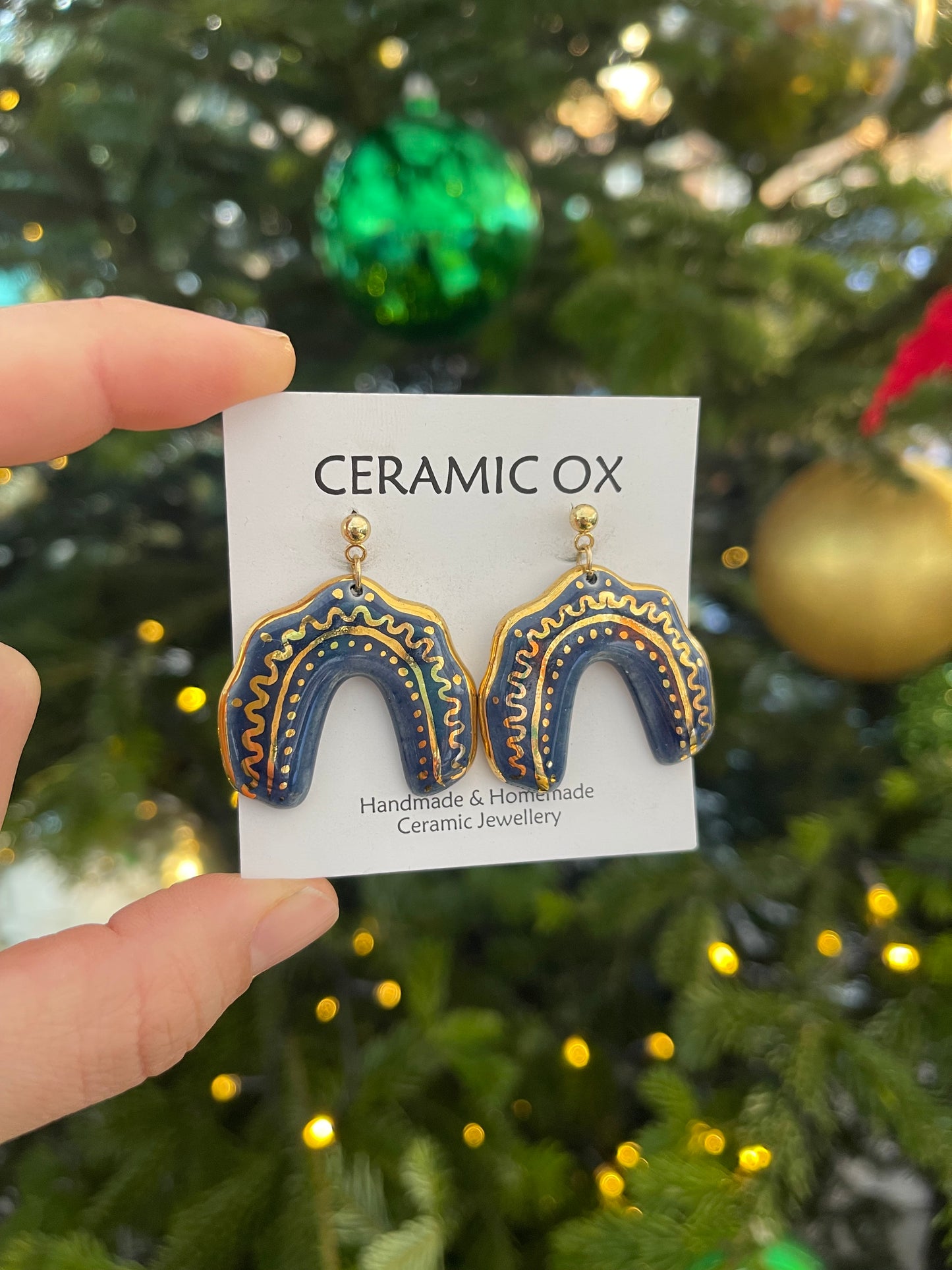 Gold design Navy dangly arches