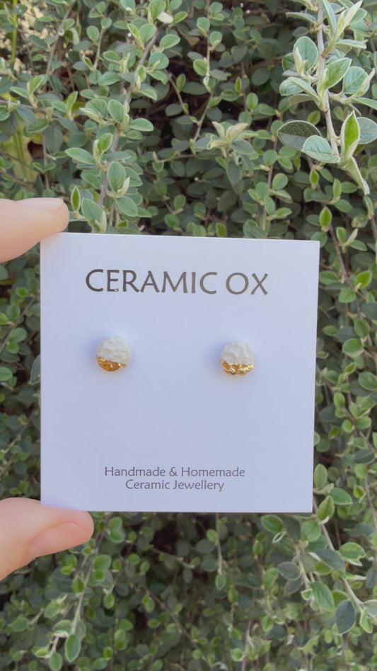 White textured studs with gold accent