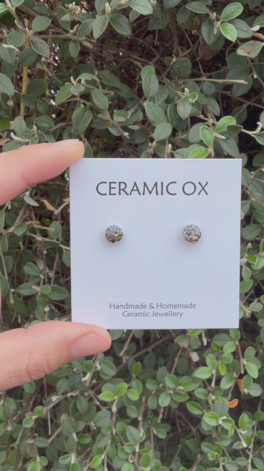Tiny textured studs in grey black with platinum