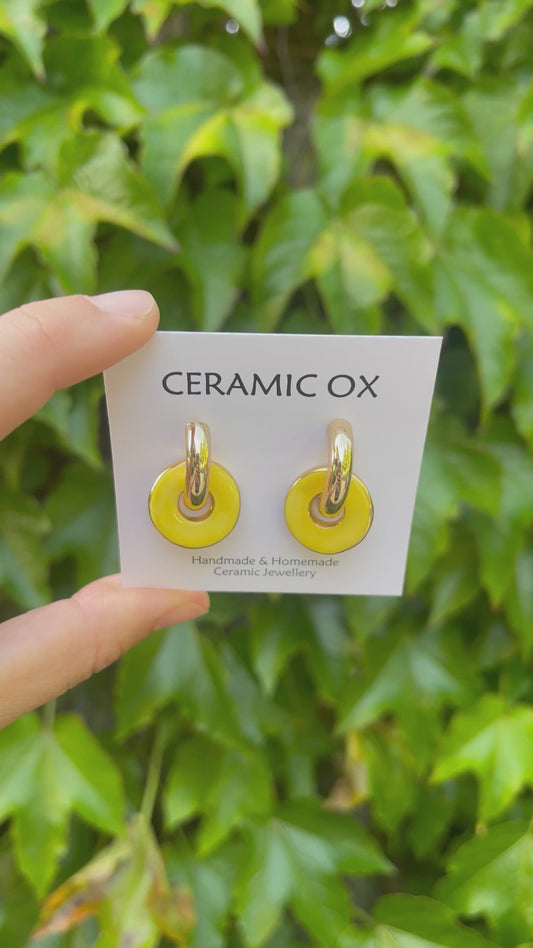 Yellow circles on chunky golden hoops